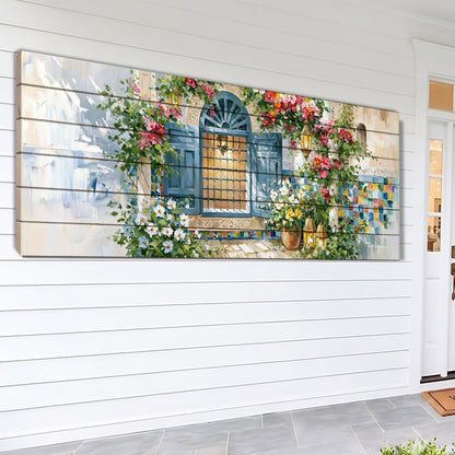 A large, colorful painting depicting a charming blue door with a decorative window, surrounded by lush greenery and flowers, mounted on a white wall.