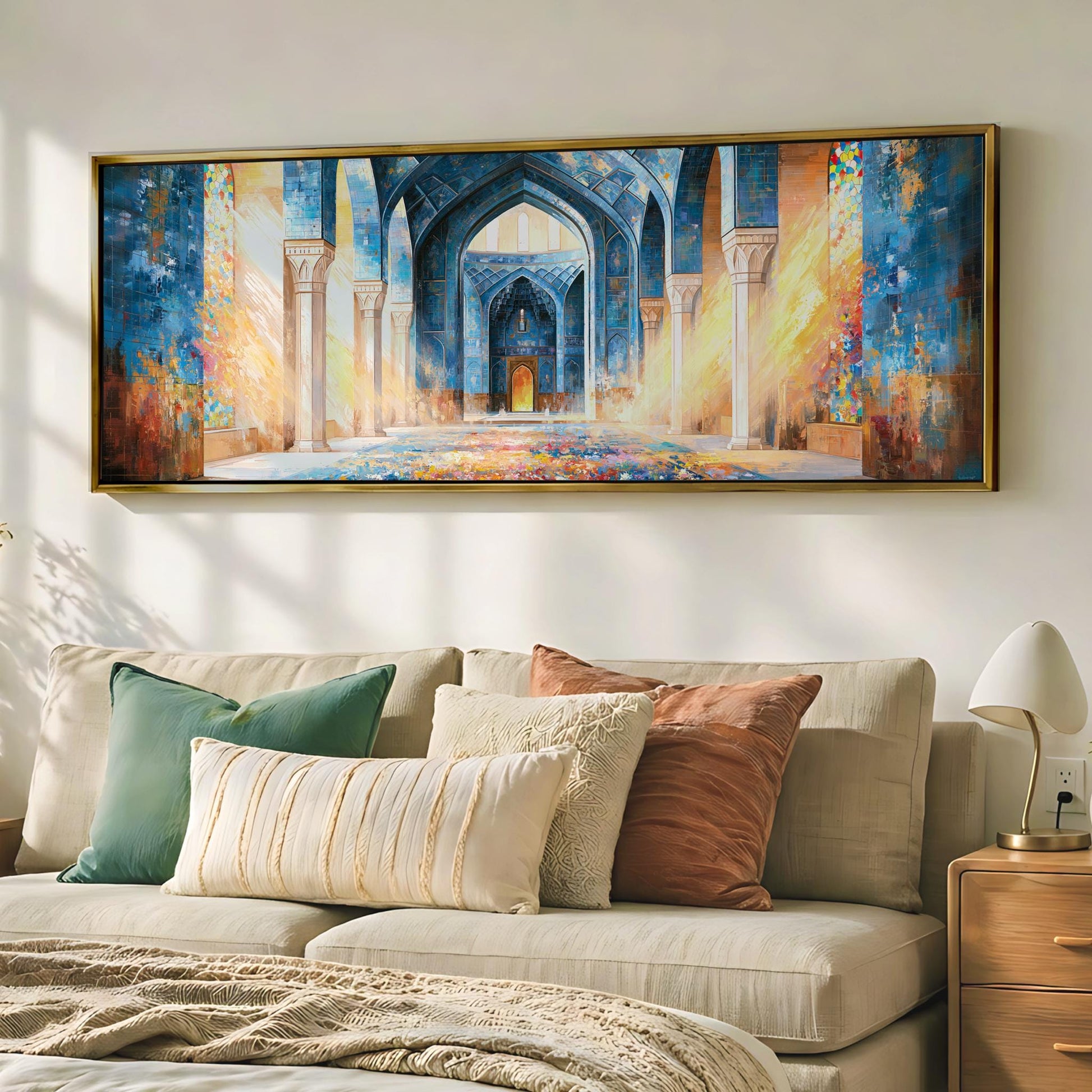 a large, colorful painting of an ornate, arched doorway hanging on a wall above a beige sofa adorned with throw pillows.
