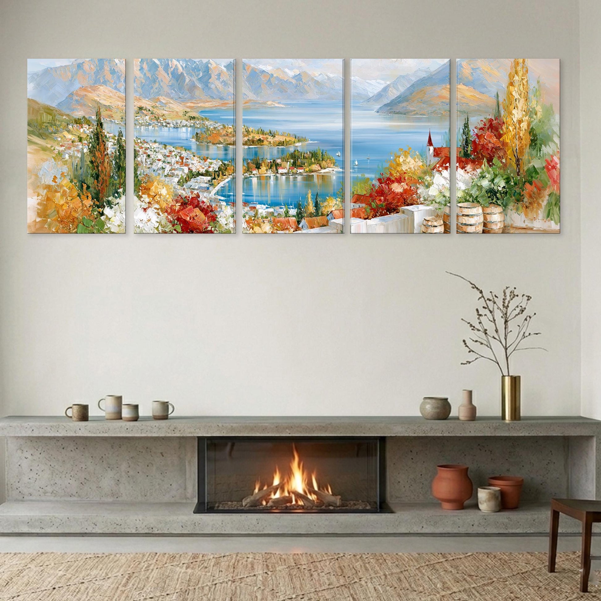 a cozy living room with a fireplace, a large wall art depicting a scenic landscape, and various decorative items on a shelf below the fireplace.