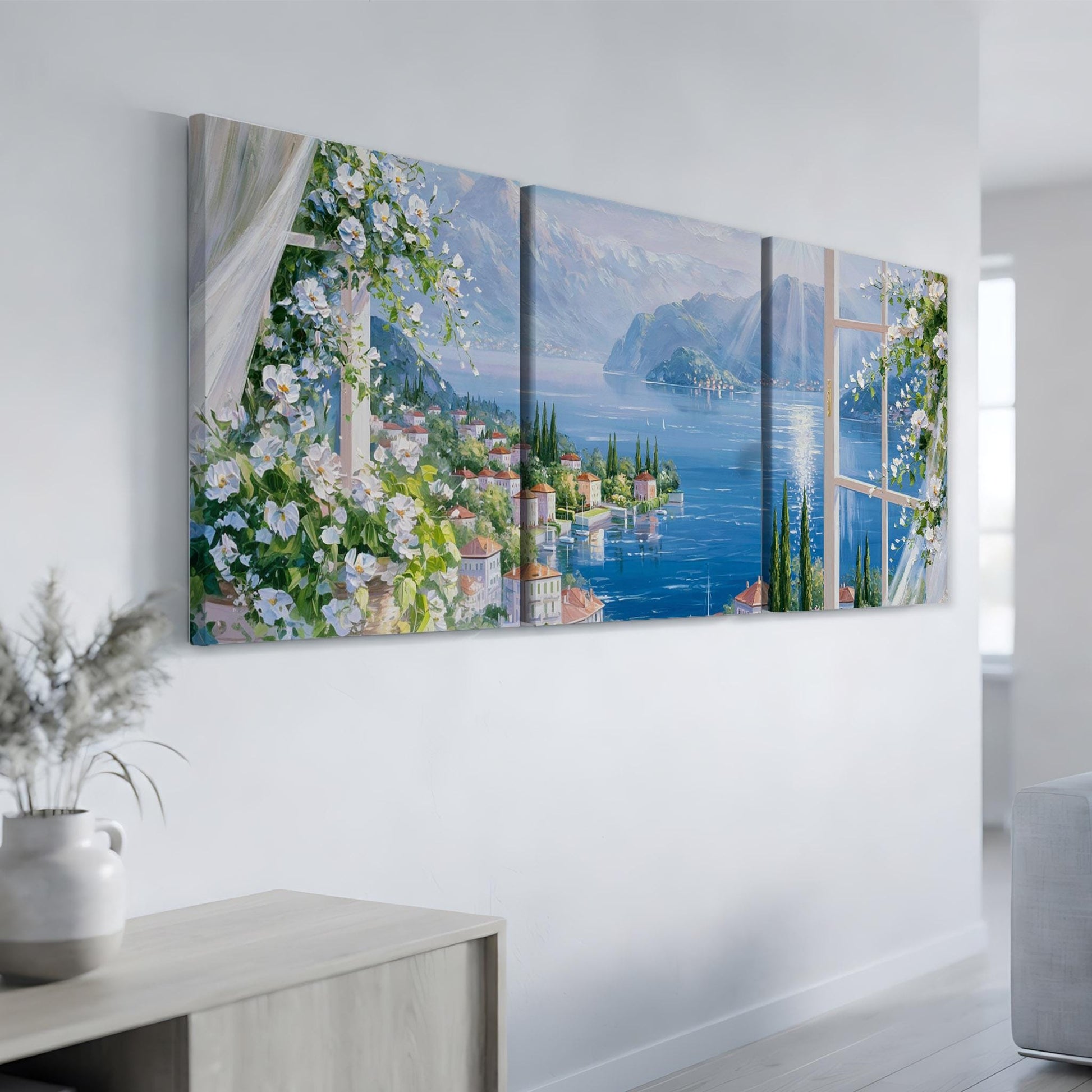 a large, three-panel painting depicting a picturesque coastal town with a harbor, surrounded by mountains and lush greenery.