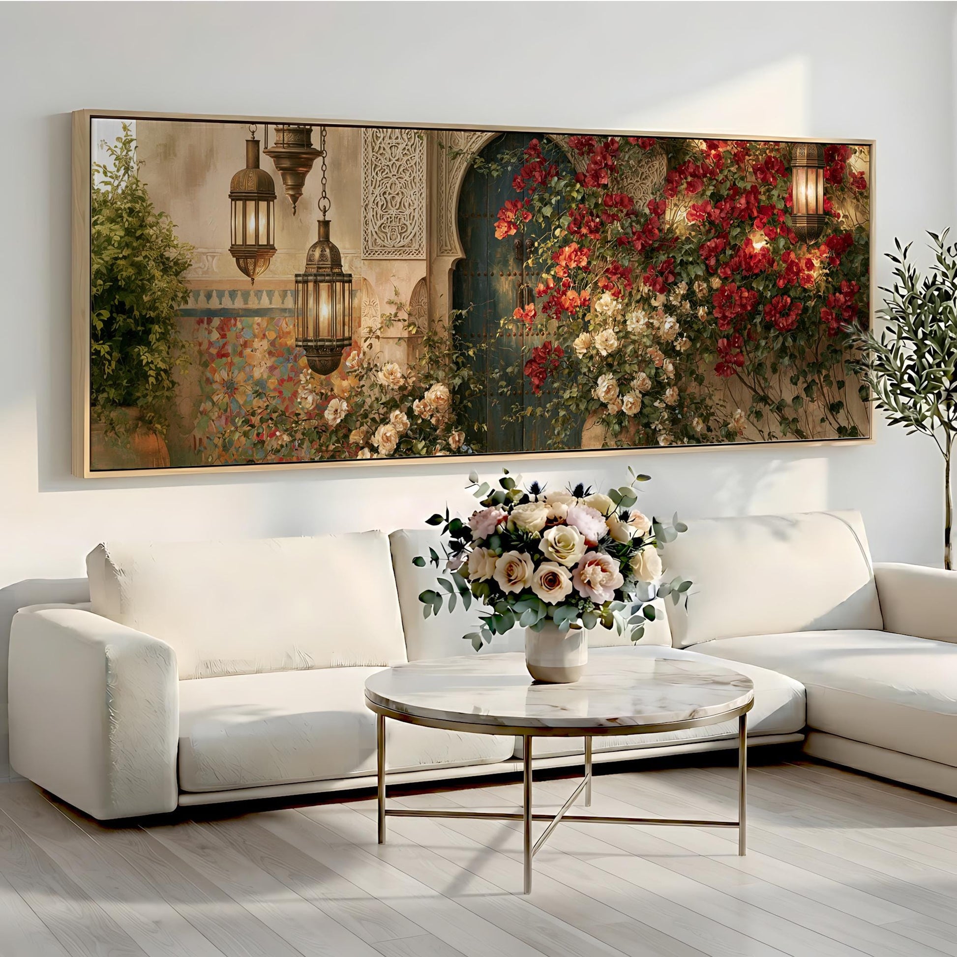 a large, ornate painting of a garden scene with hanging lanterns and a vase of flowers on a white sofa in a living room setting.