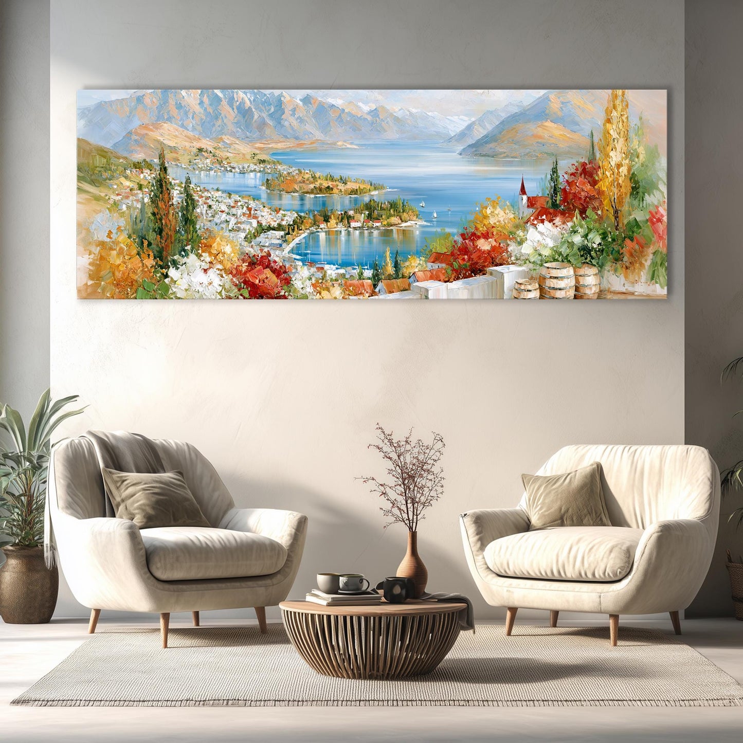 a large, colorful painting of a scenic landscape with mountains, a lake, and a town, hanging on a wall above a living room with two white armchairs and a coffee table.