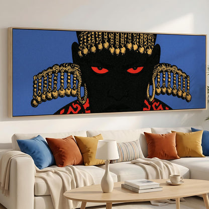 a large, colorful painting of a person's face with striking red eyes and gold accents, hanging on a wall above a white couch with colorful throw pillows.