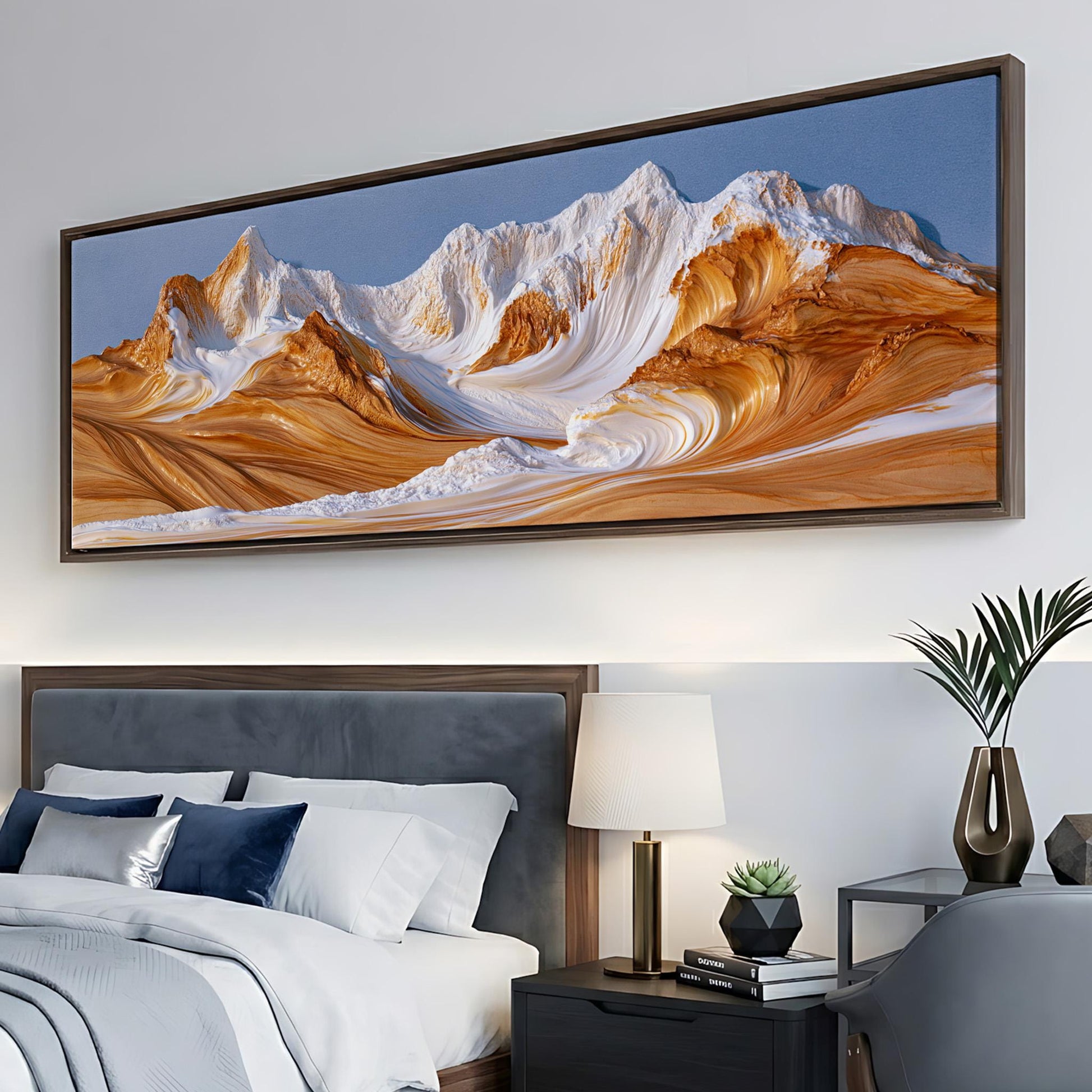 a large, framed painting of a mountain landscape hanging on a wall above a bed with white bedding and blue pillows.